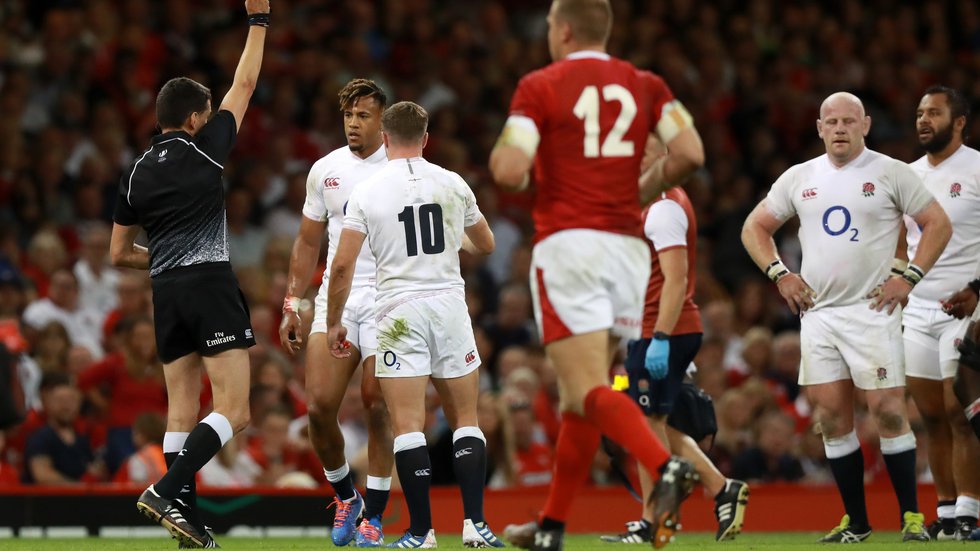 Anthony Watson is shown a yellow card for a deliberate knock-on against Wales in Cardiff